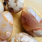 Underside view of Grade AA Flower Agate palm stone, associated with Love.