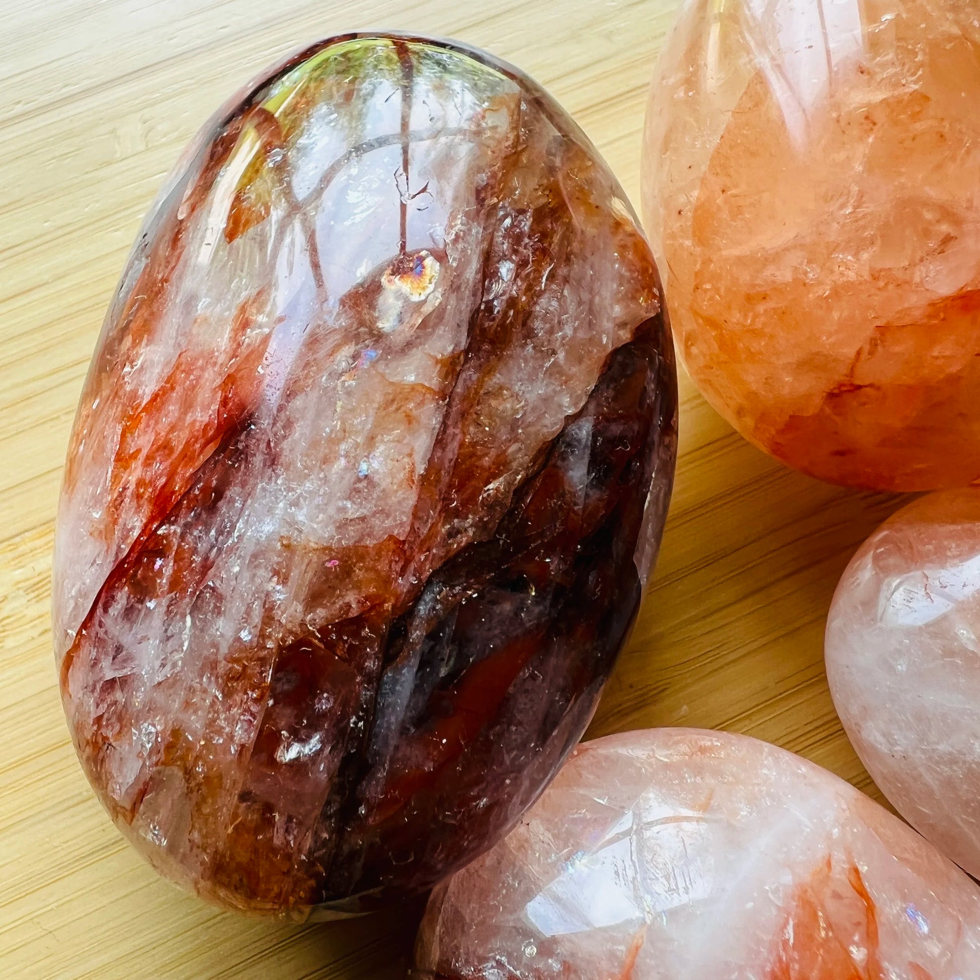 Near view of red Fire Quartz palm stone, showing soft luster.