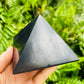 Profile shot of Shungite polished pyramid, carried for Protection.