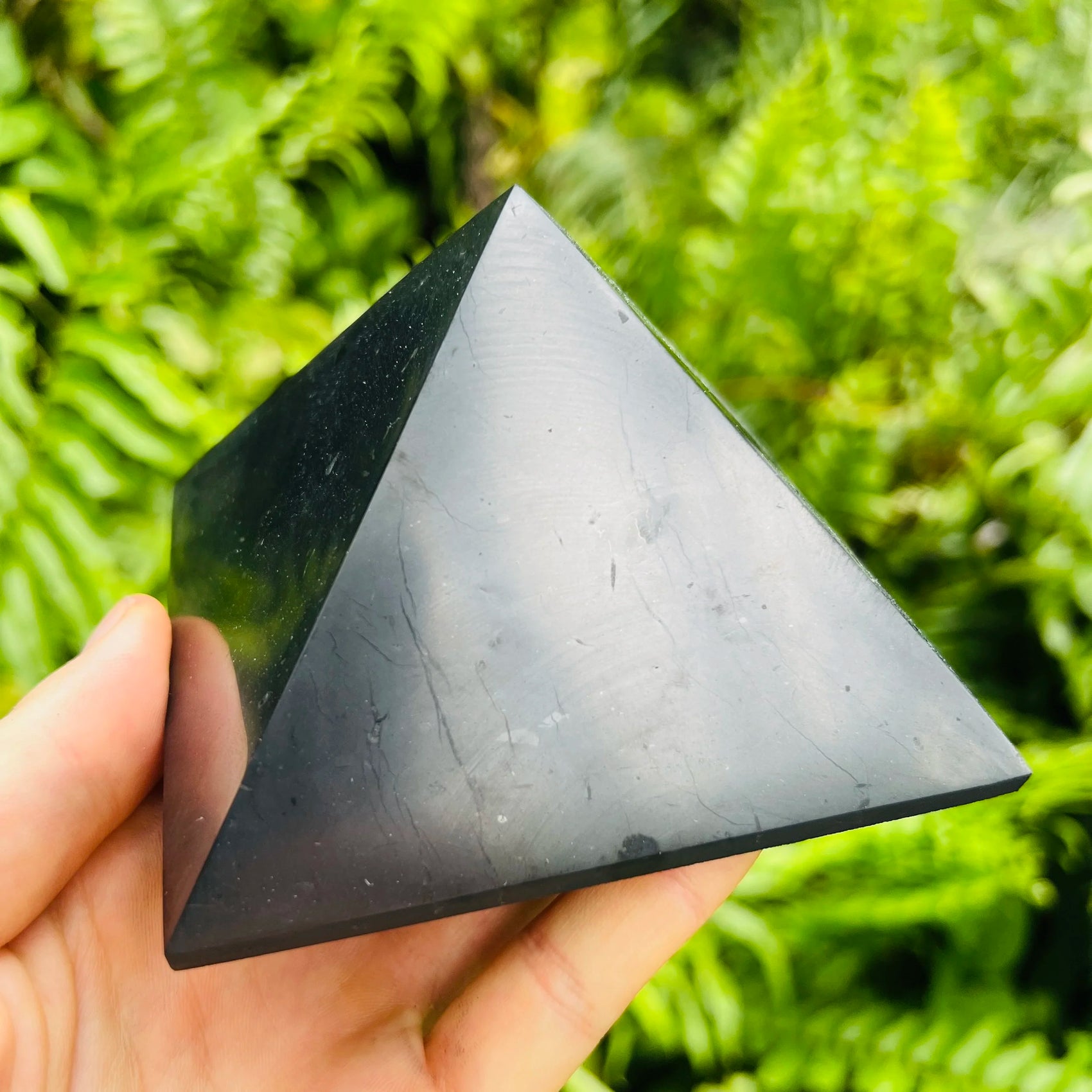 Profile shot of Shungite polished pyramid, carried for Protection.