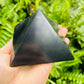 Back view of Shungite polished pyramid, showing glassy finish.
