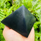 Daylight view of a Shungite polished pyramid associated with Protection and Cleansing.