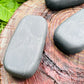 Held in hand, one Shungite palm stone for scale, Russia-sourced.