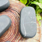 Back view of Grade Type III - Regular Grade Shungite palm stone showing natural surface