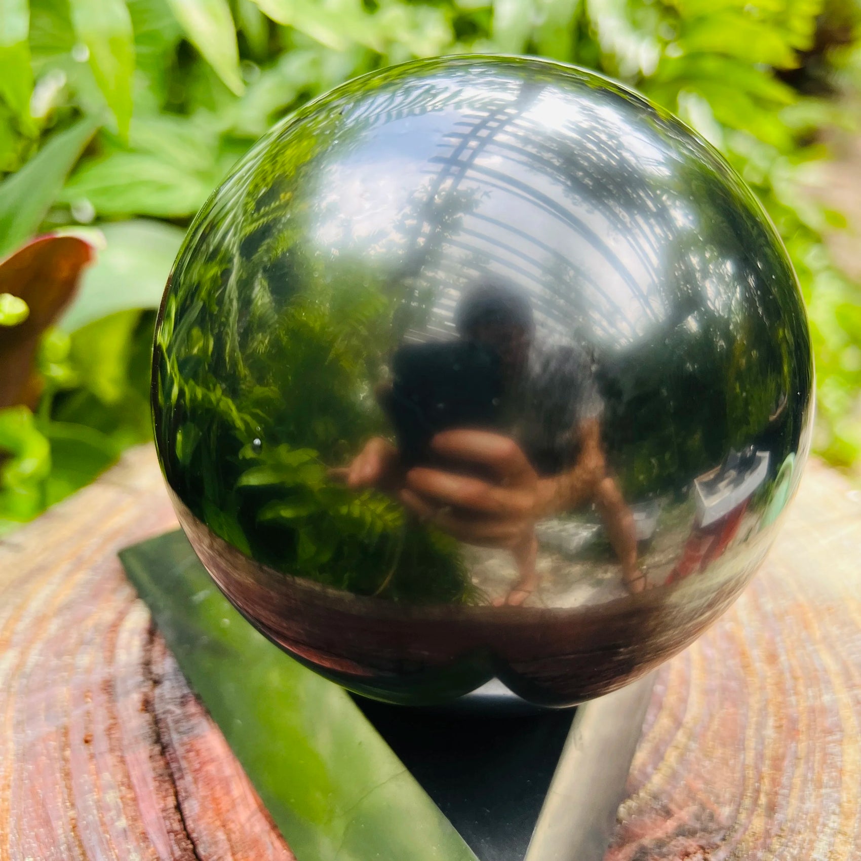 Side-on view of Shungite polished sphere, sourced from Republic of Karélia, Russia.