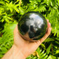 Close-up of Shungite sphere from Russia, soothing wellness stone for Stress Relief