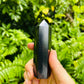 Sideways view of Shungite polished point, associated with Protection and Cleansing, hand-selected from Republic of Karélia, Russia.