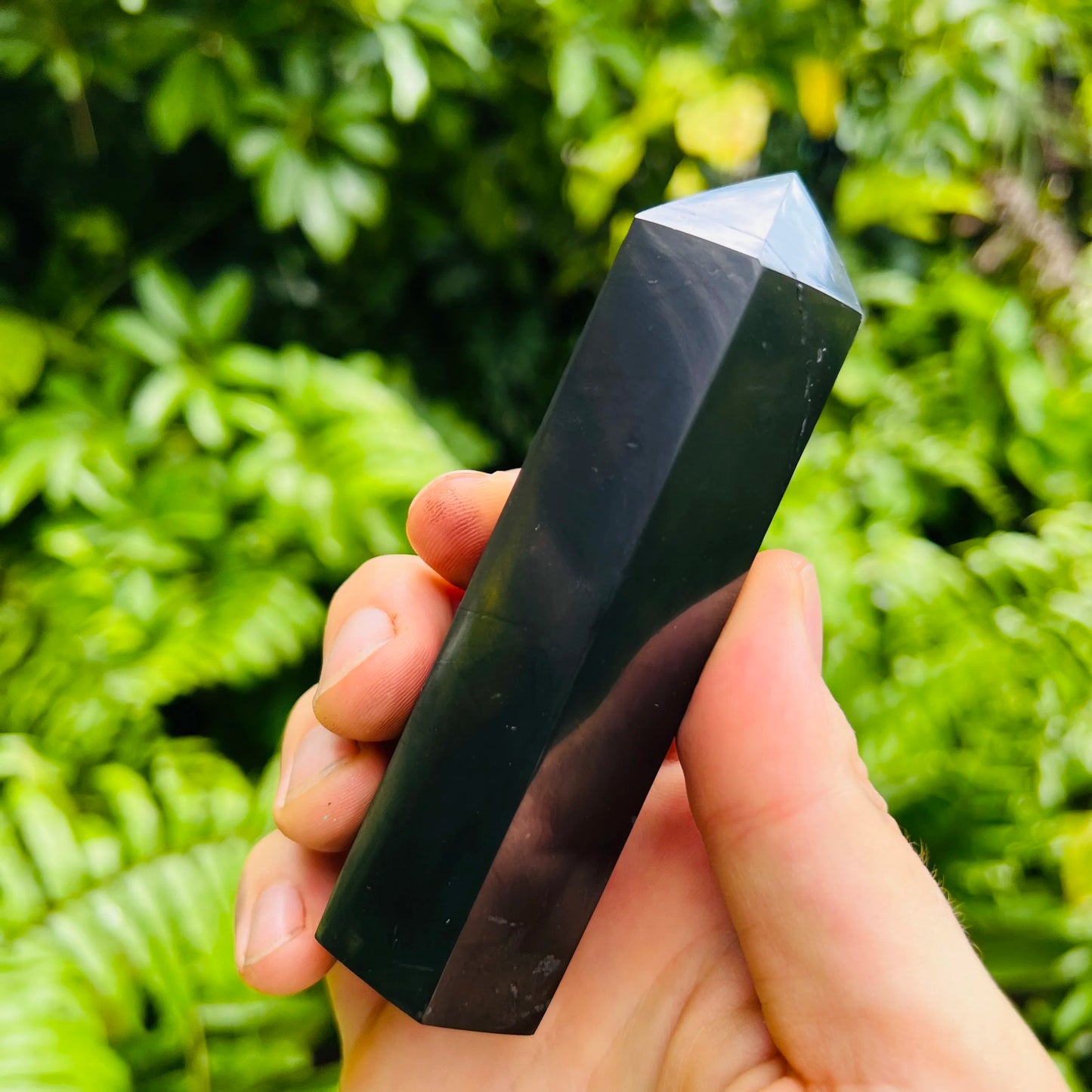 Aerial view of Shungite polished point, showing natural inclusions, worked with for Protection and Cleansing.