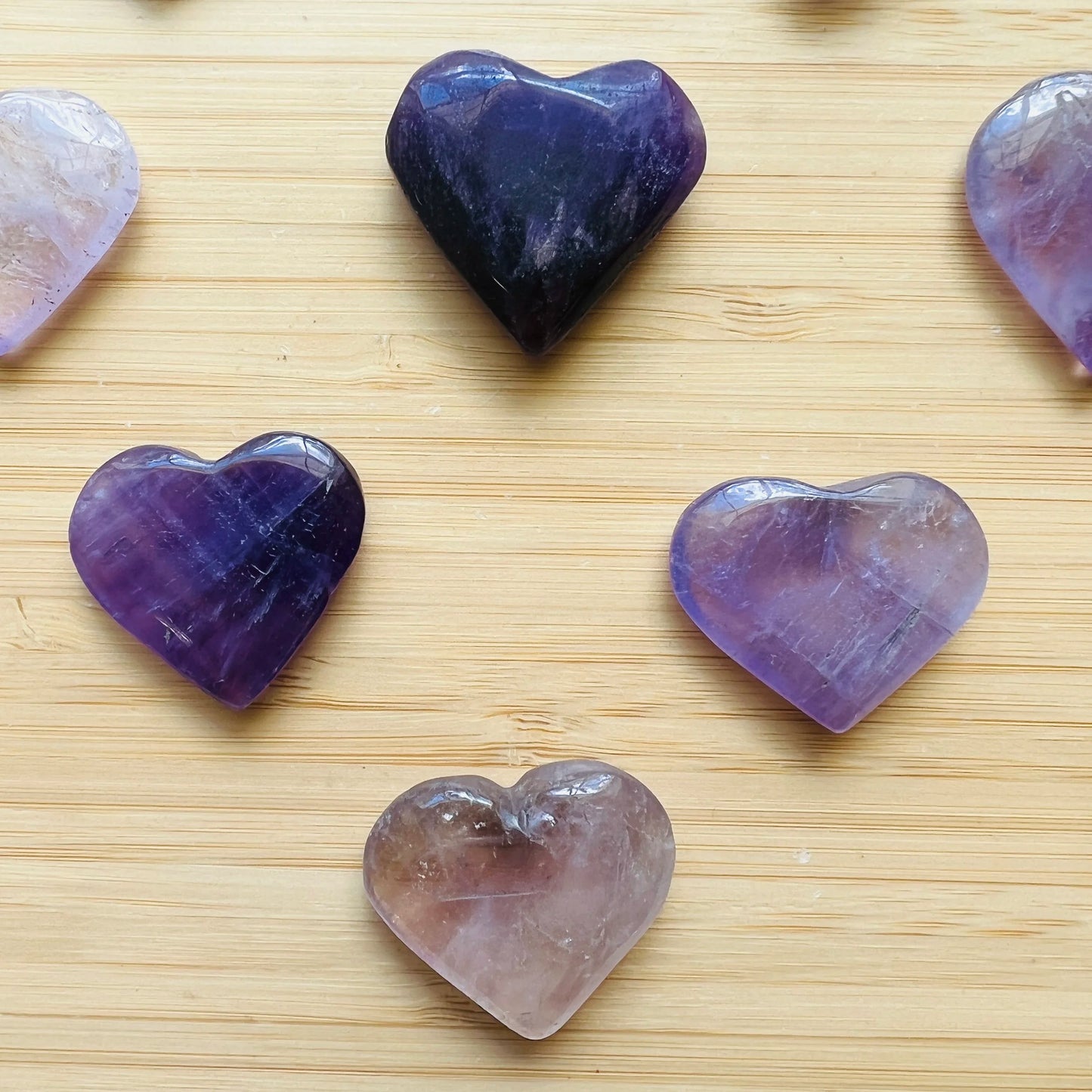 Overhead view of Amethyst polished heart, showing glassy finish, kept near for Stress Relief and Sleep.
