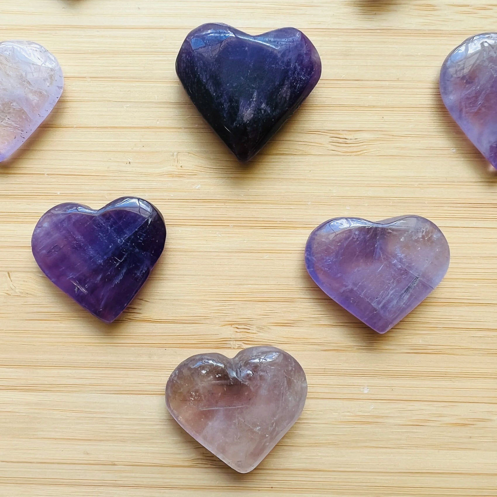 Overhead view of Amethyst polished heart, showing glassy finish, kept near for Stress Relief and Sleep.