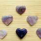 Palm-scale view of a single Amethyst polished heart Brazil-sourced, sourced from Rio Grande do Sul, Brazil.
