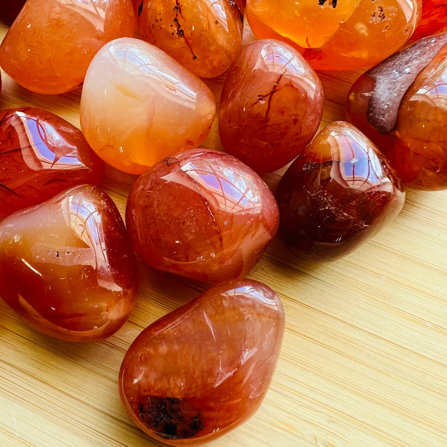 Side profile of Grade AA Carnelian tumbled stone with natural form and inclusions