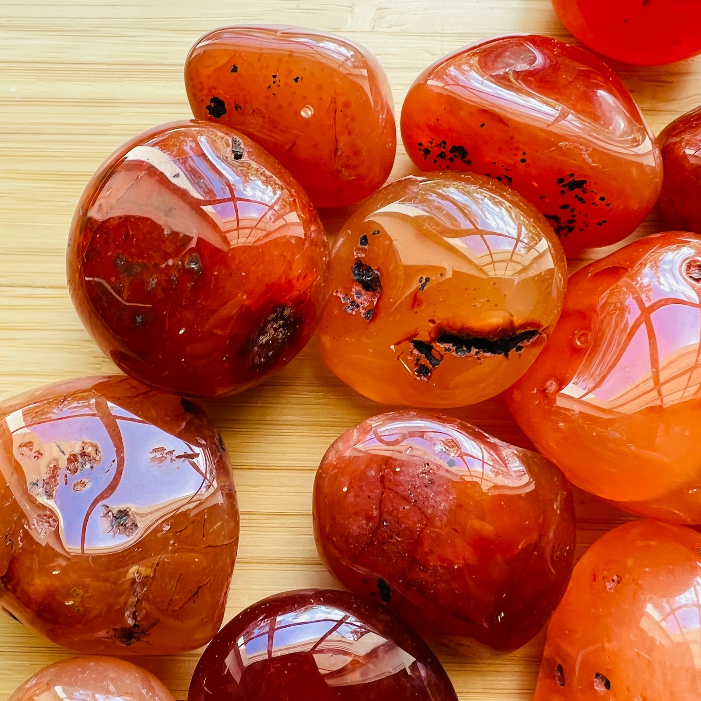 Top view of Grade AA Carnelian tumbled stone, sourced from Paraná, Brazil