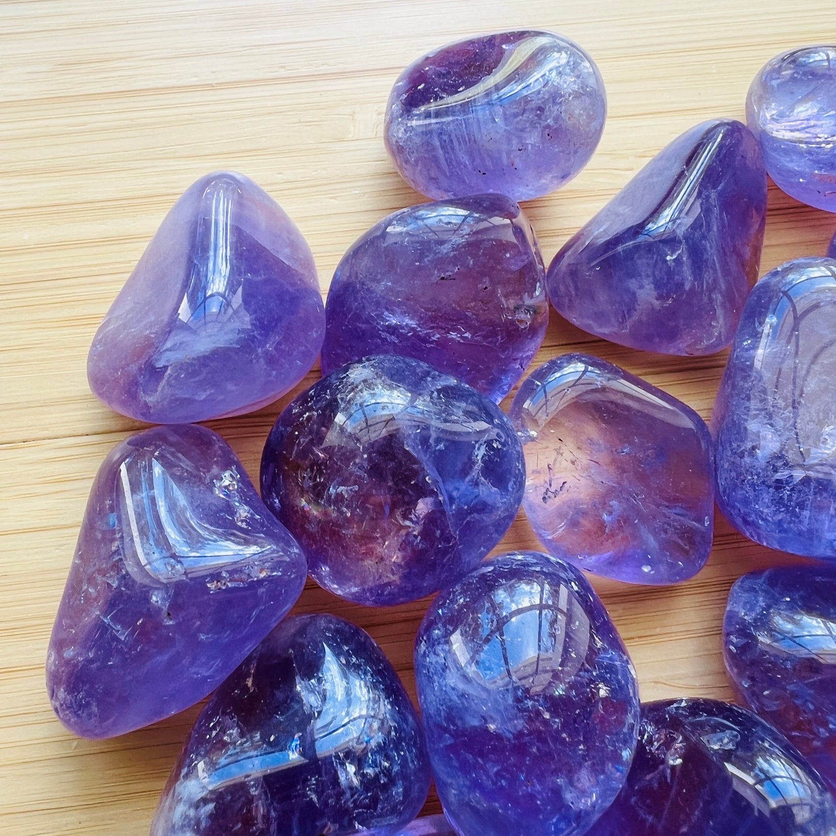 Side perspective of Amethyst tumbled stone, drawn on for Stress Relief and Sleep.
