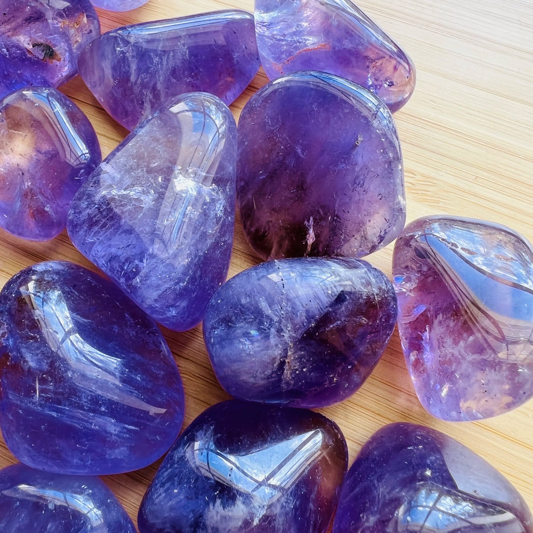 Bottom side of purple Amethyst tumbled stone, from Rio Grande do Sul, Brazil, showing glassy finish.