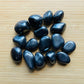 Detail shot showing Hematite tumbled stone, linked to Grounding.