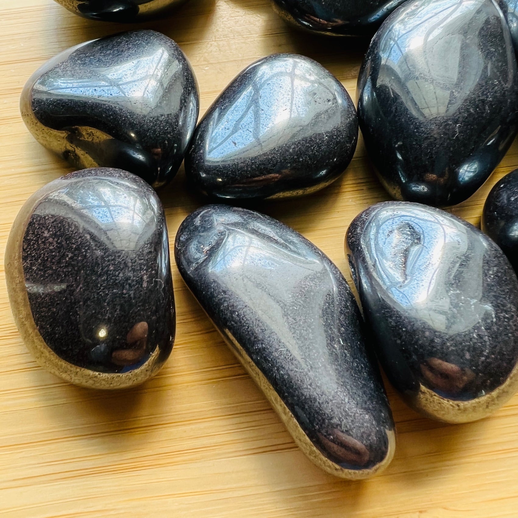 Close-up of Hematite tumbled stone from Brazil, soothing wellness stone for Stress Relief