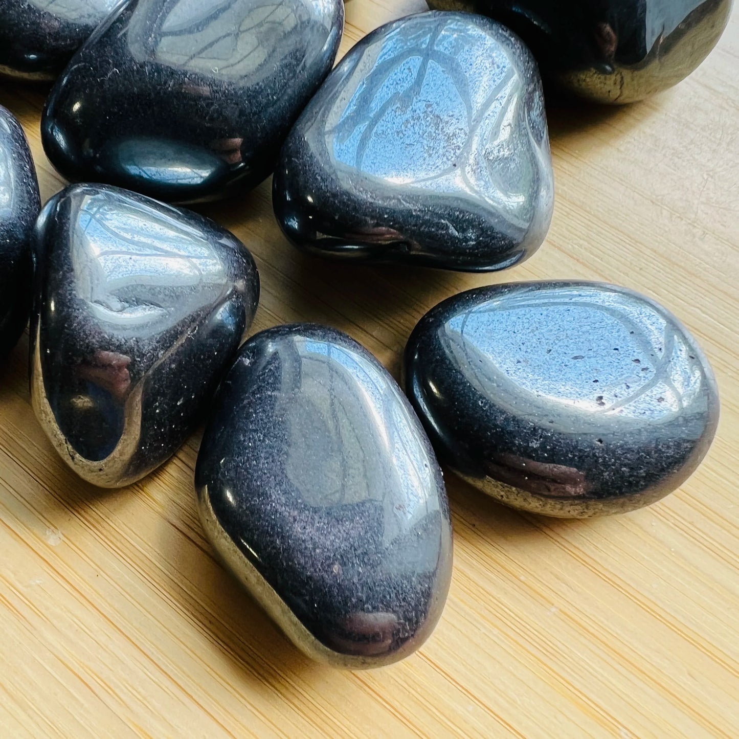Alternate side of gray Hematite tumbled stone, showing characteristic color.