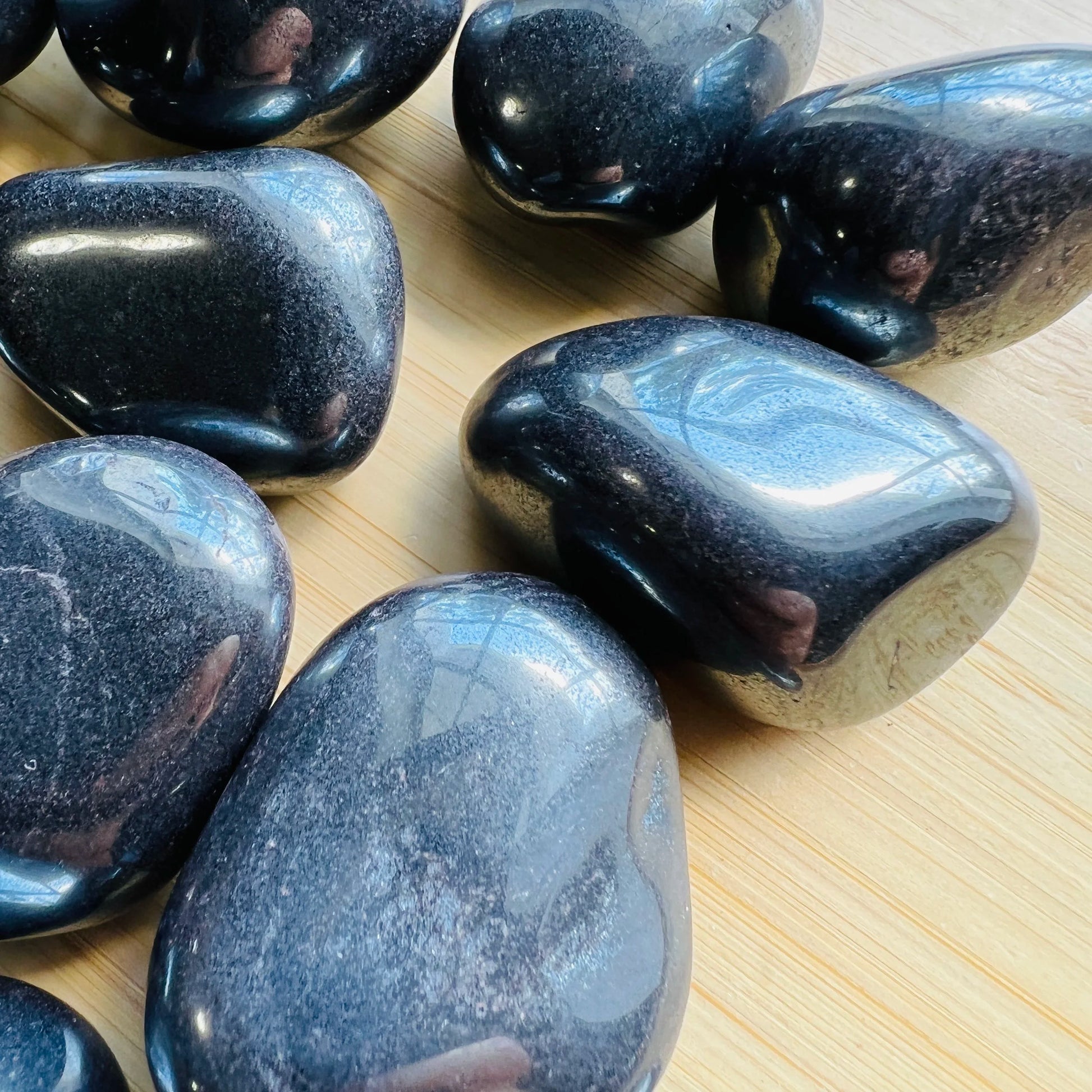 Lifestyle view of a single Hematite tumbled stone from Minas Gerais, Brazil.