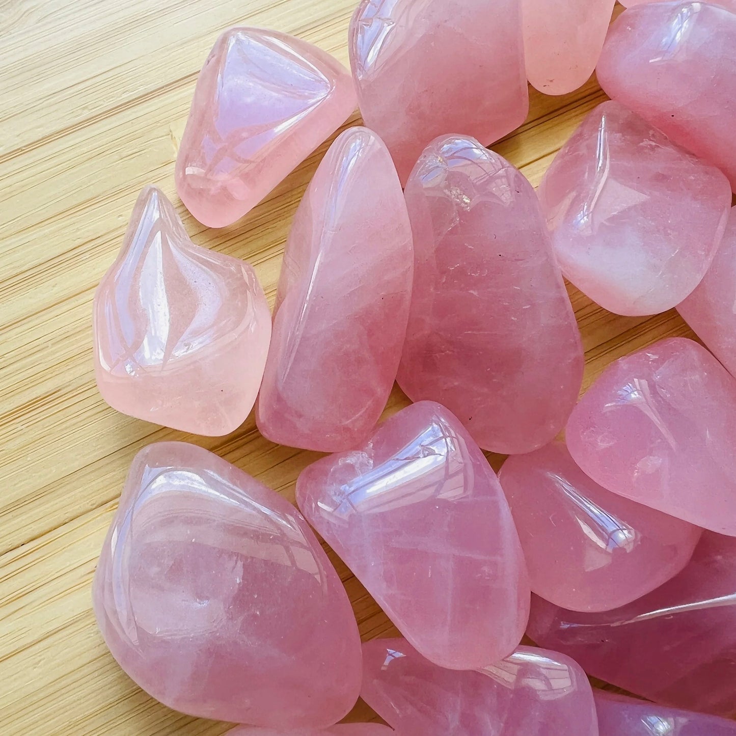 Profile shot of Grade AA pink Rose Quartz tumbled stone, from Vakinankaratra, Madagascar, showing glassy finish.