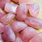 Reverse angle of Rose Quartz tumbled stone, showing soft luster, turned to for Love.