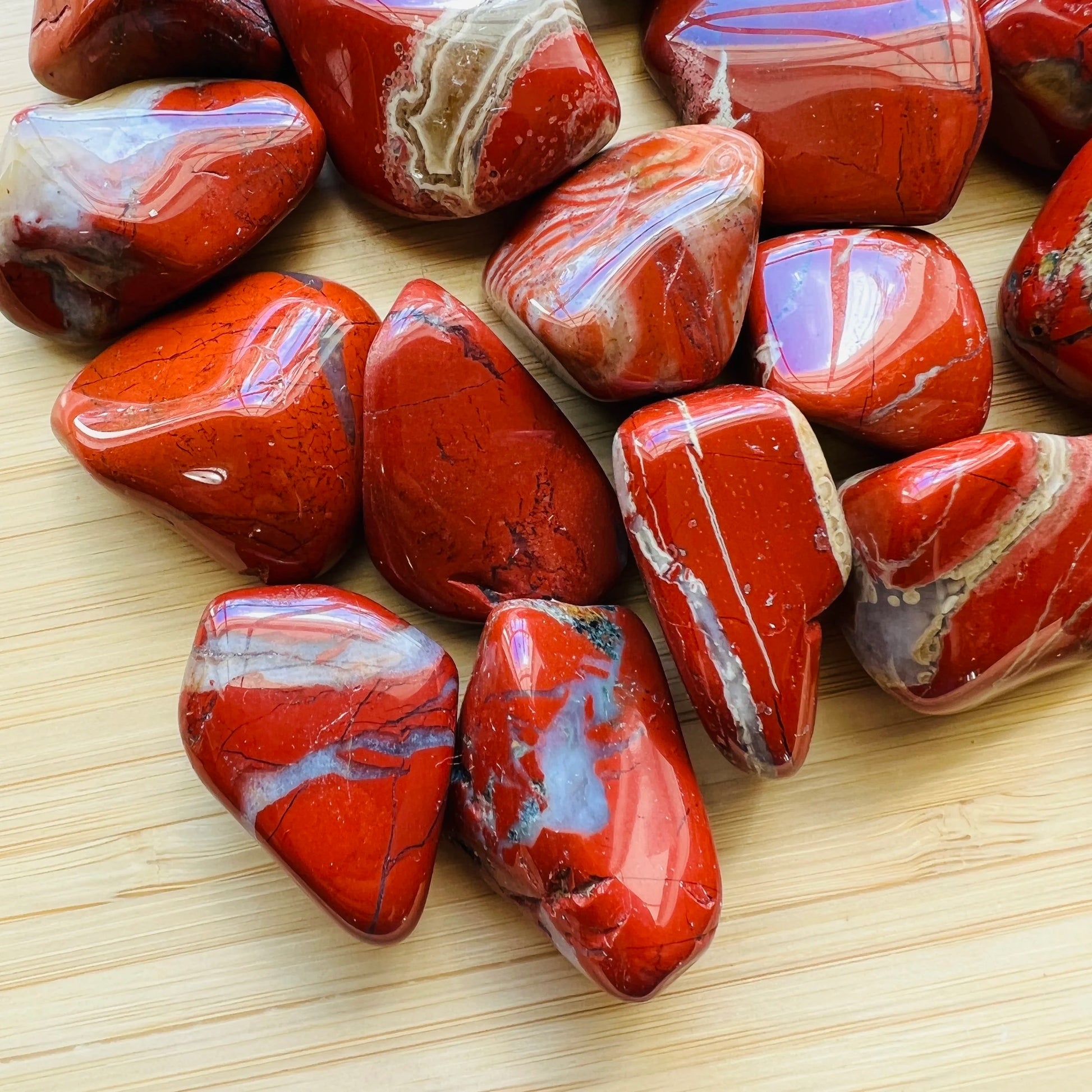 Close-up of Red Jasper tumbled stone from South Africa, soothing wellness stone for Confidence