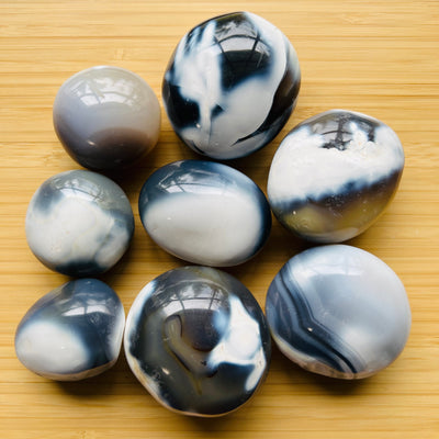 Orca Agate palm stone in Blue, White tones, ethically sourced from Madagascar for Emotional Healing and Stress Relief