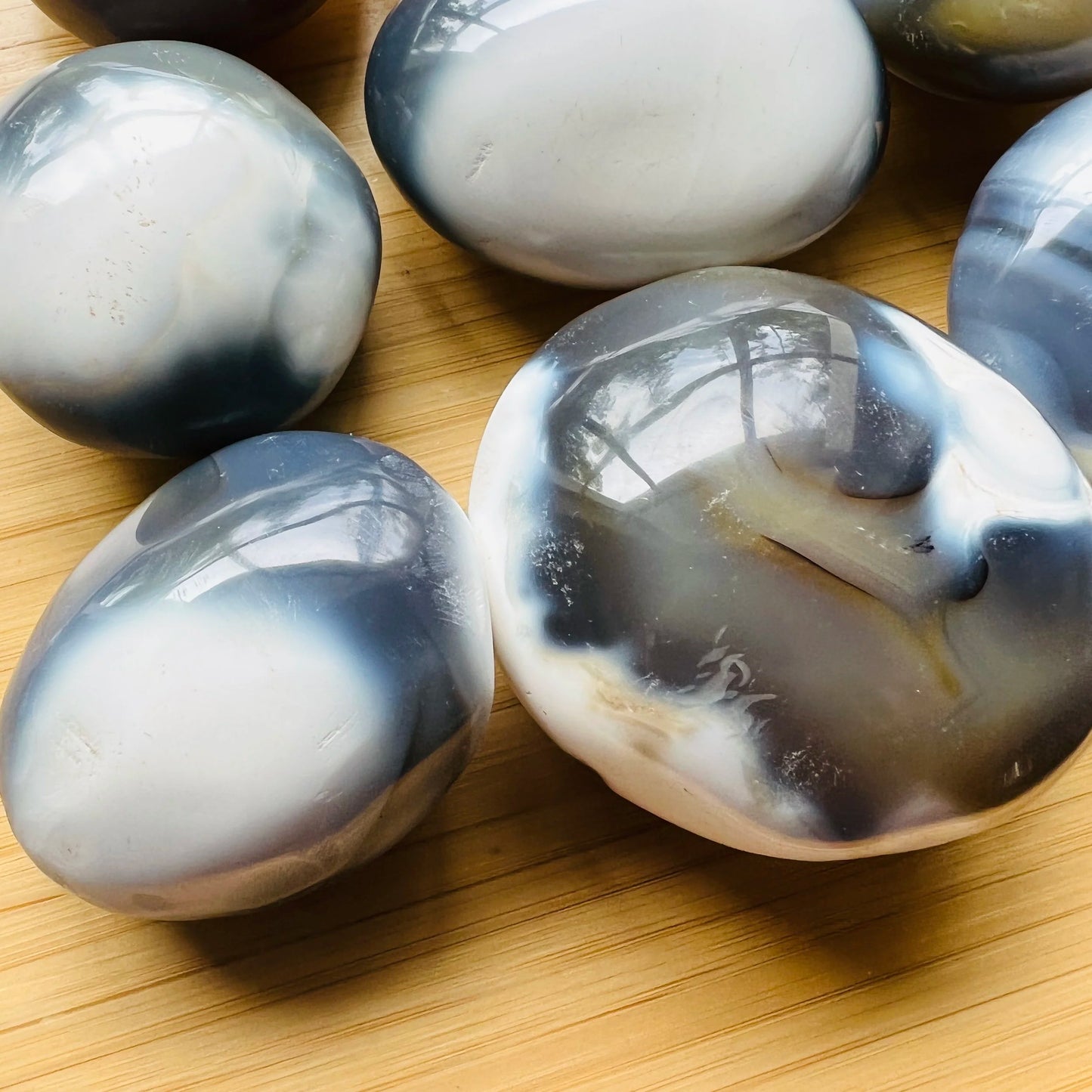 Color detail of Grade AA Orca Agate palm stone, often kept for Stress Relief and Emotional Healing, from Sofia, Madagascar.