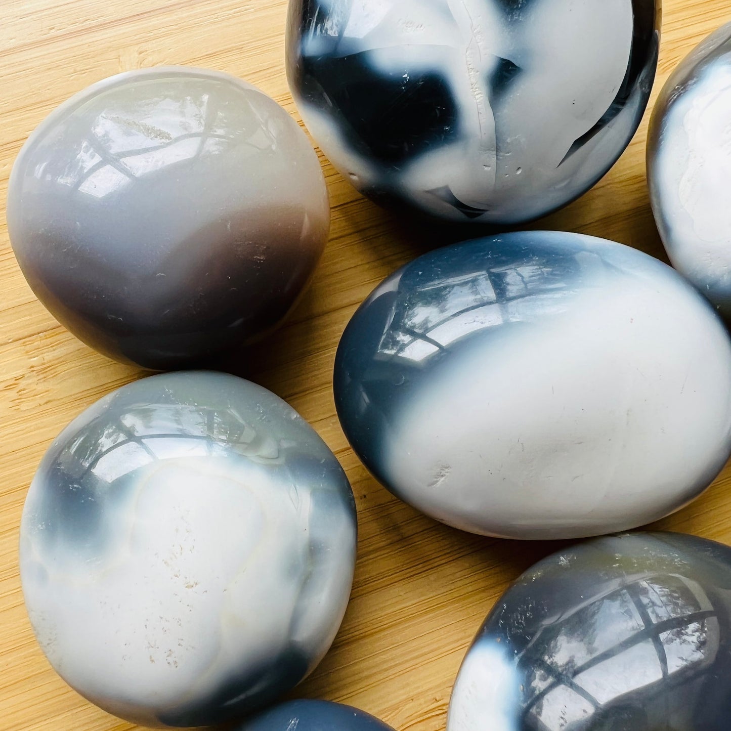 Side profile of Orca Agate palm stone, showing subtle veining.