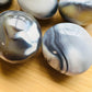 Top angle of Orca Agate palm stone, often kept for Stress Relief.