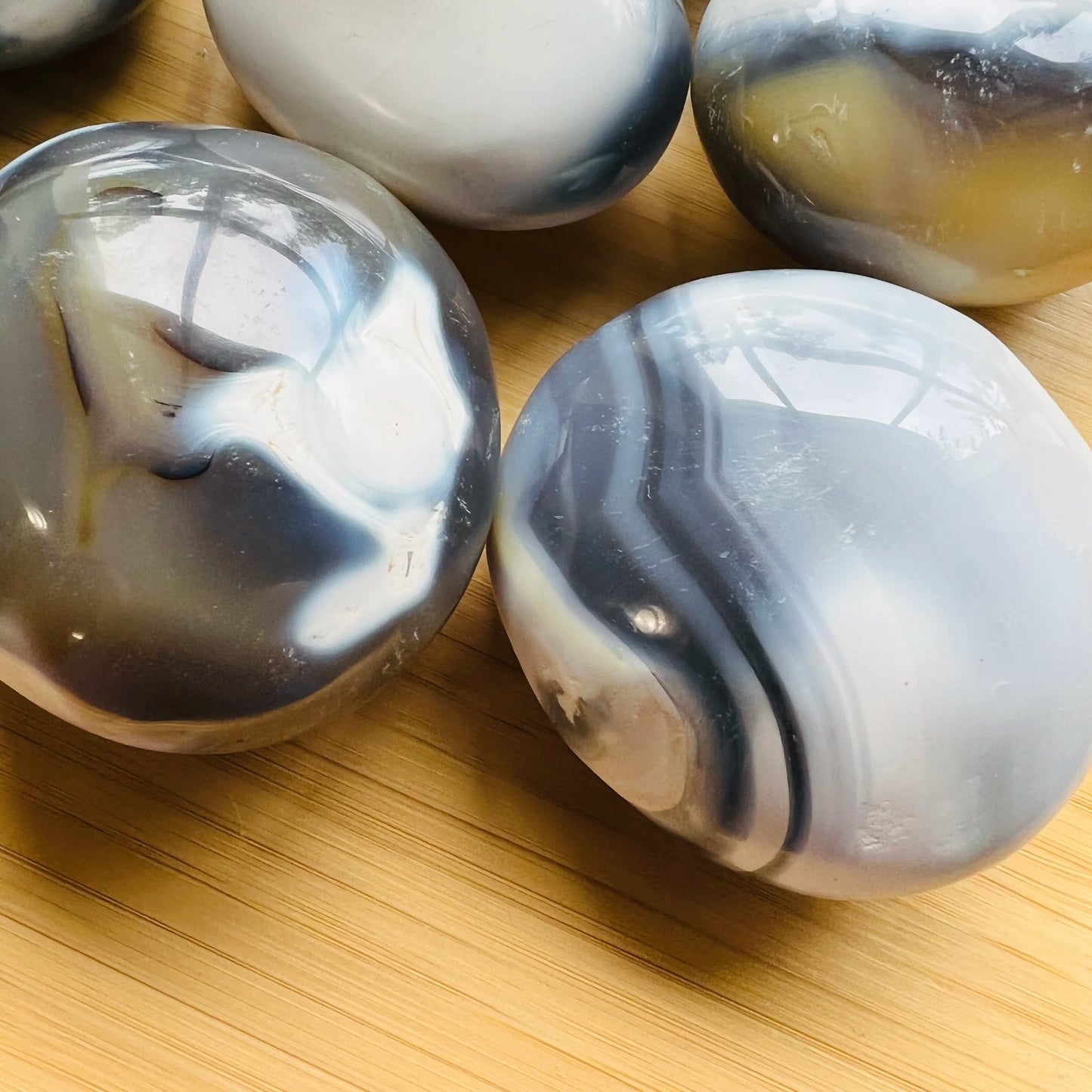Top angle of Orca Agate palm stone, often kept for Stress Relief.