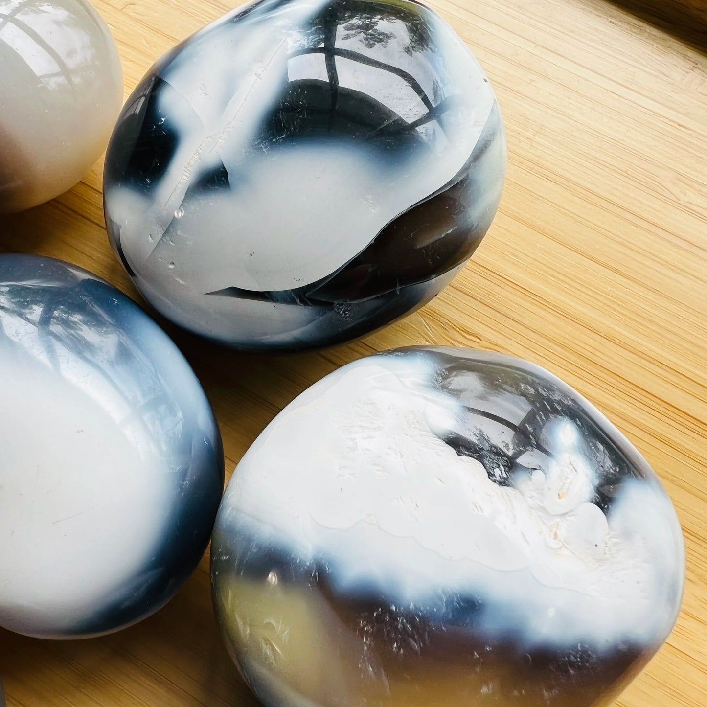 Alternate angle of Orca Agate palm stone, showing subtle veining.