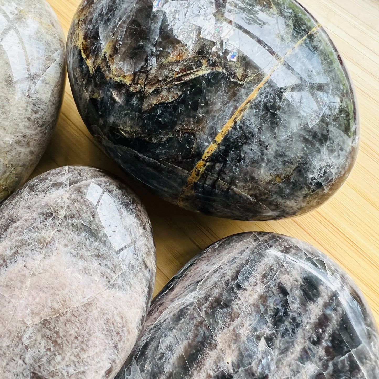 Opposite side of Black Moonstone palm stone, from Amoron'i Mania, Madagascar, traditionally used for Grounding and Protection.