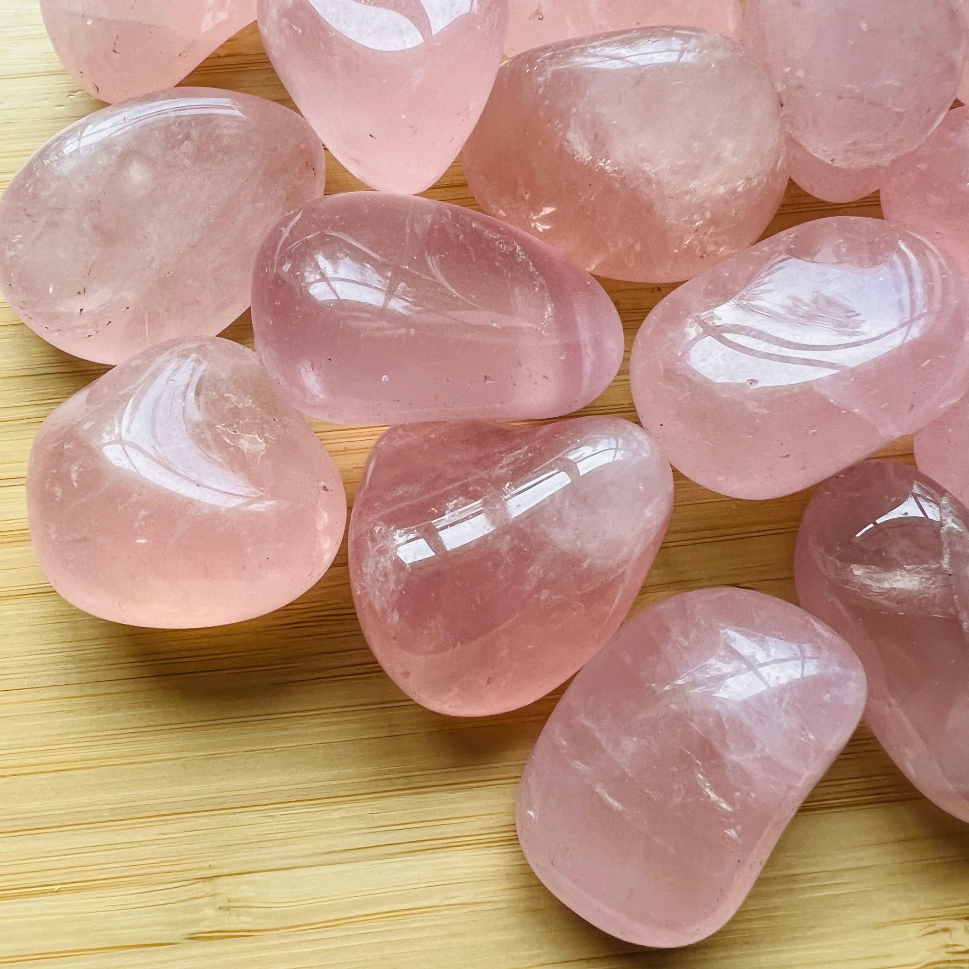 Close-up detail of Grade AAA Rose Quartz tumbled stone showing natural pink tones and texture
