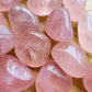 Alternate angle of Grade AAA Rose Quartz tumbled stone showing overall shape