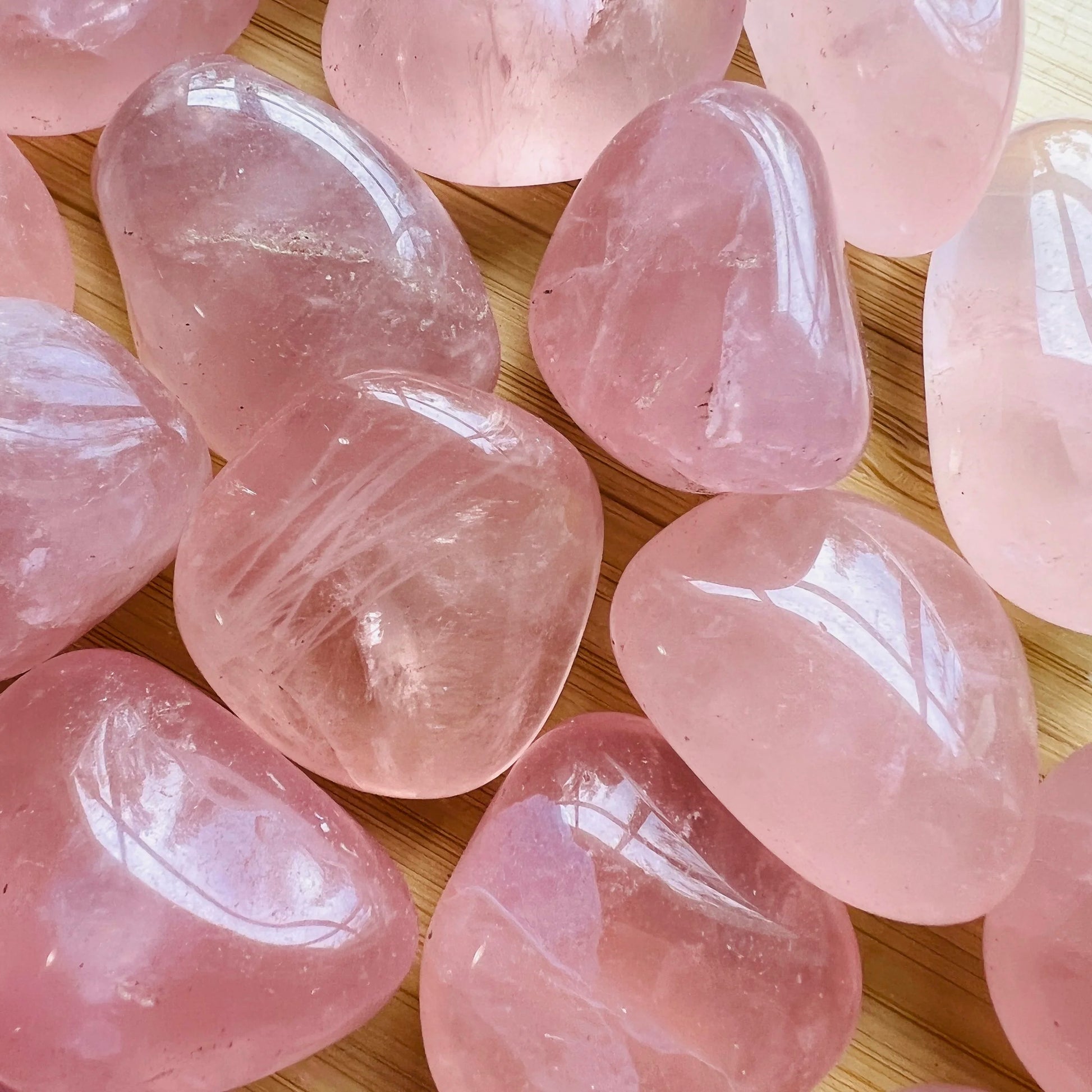 Alternate angle of Grade AAA Rose Quartz tumbled stone showing overall shape