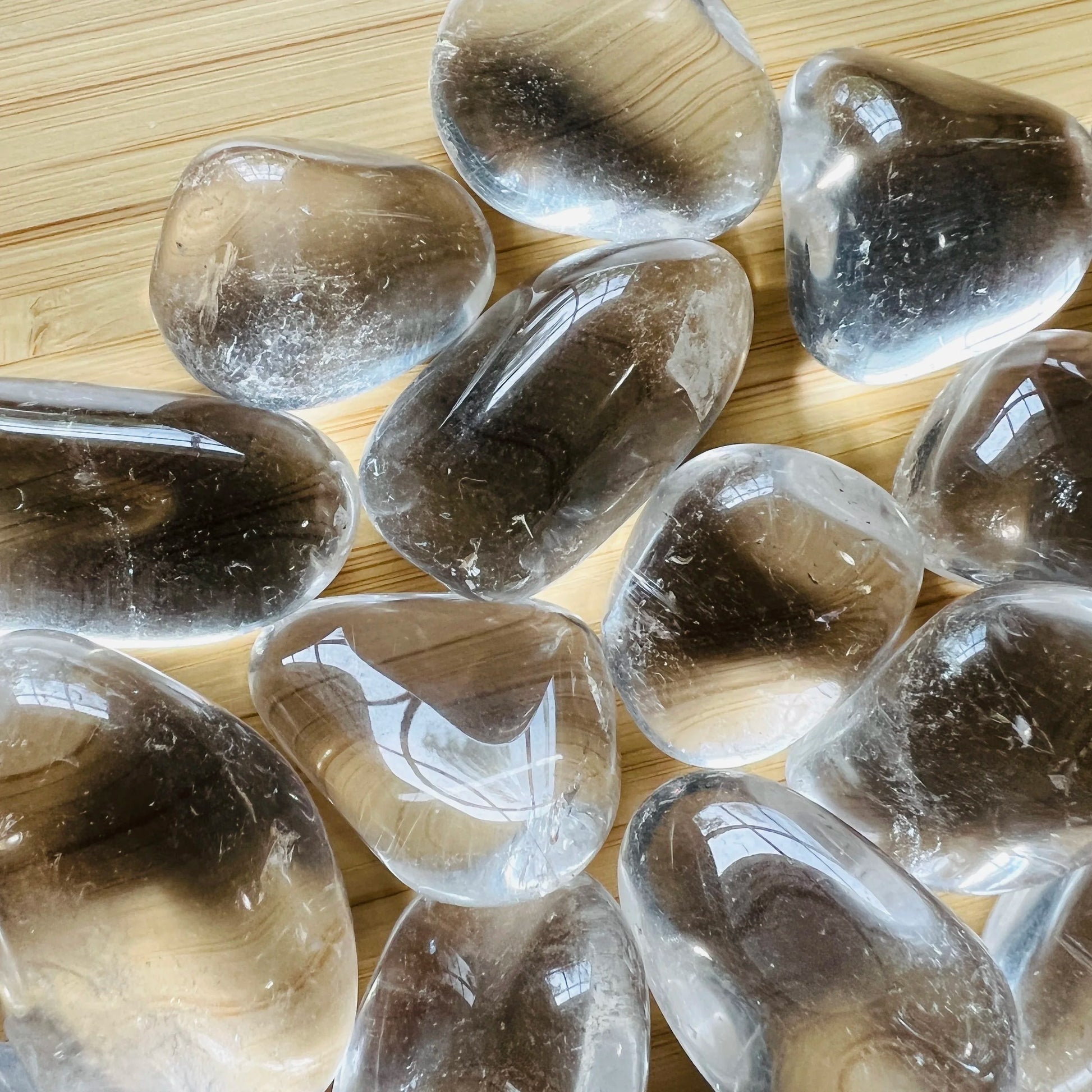 Top-down shot of Clear Quartz tumbled stone, hand-selected from Minas Gerais, Brazil, showing matte finish.