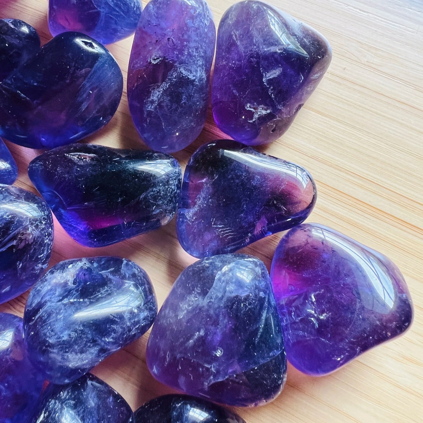 Detail shot of Grade AAA Amethyst tumbled stone under natural light