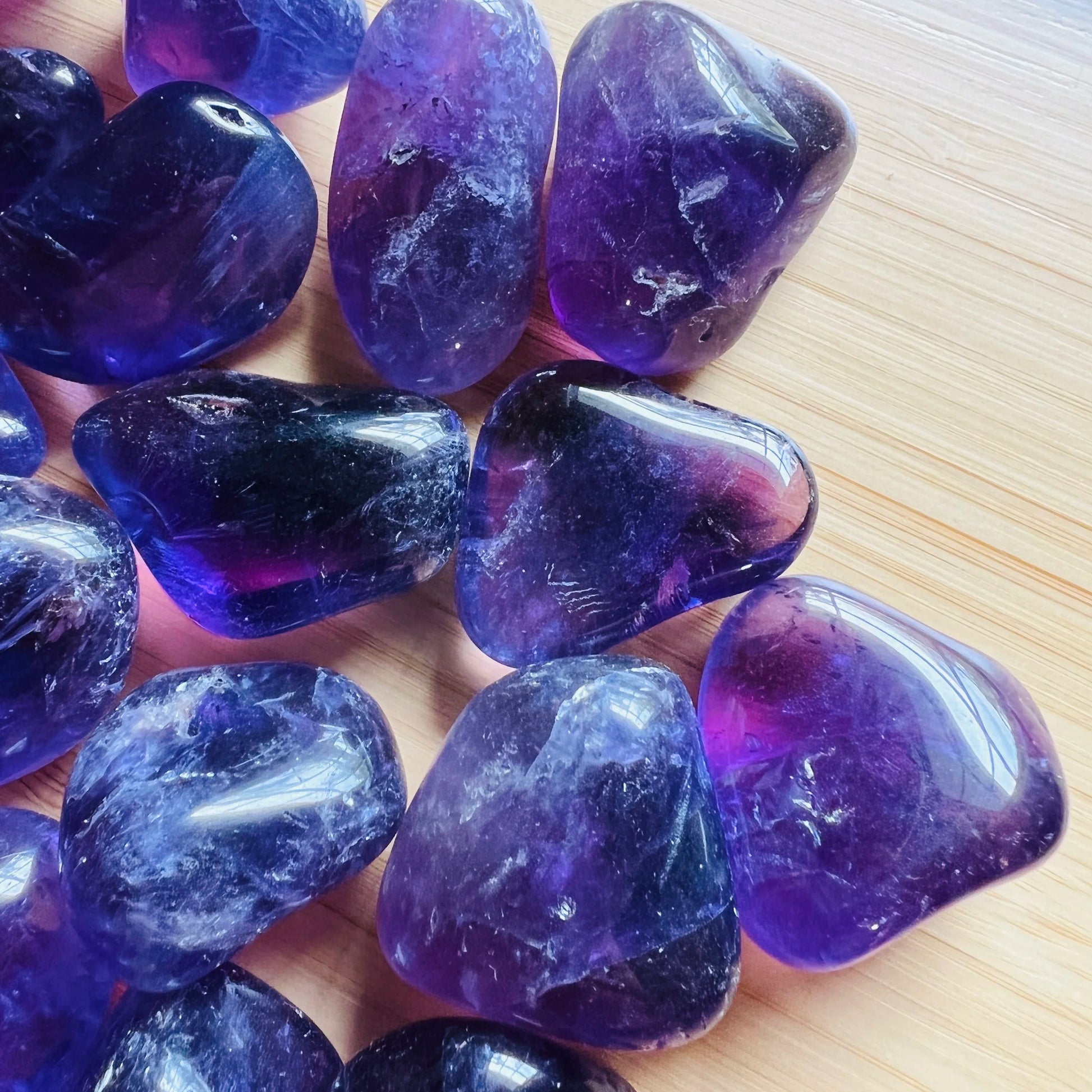 Detail shot of Grade AAA Amethyst tumbled stone under natural light