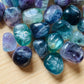 Back view of Grade AA Fluorite tumbled stone showing natural surface