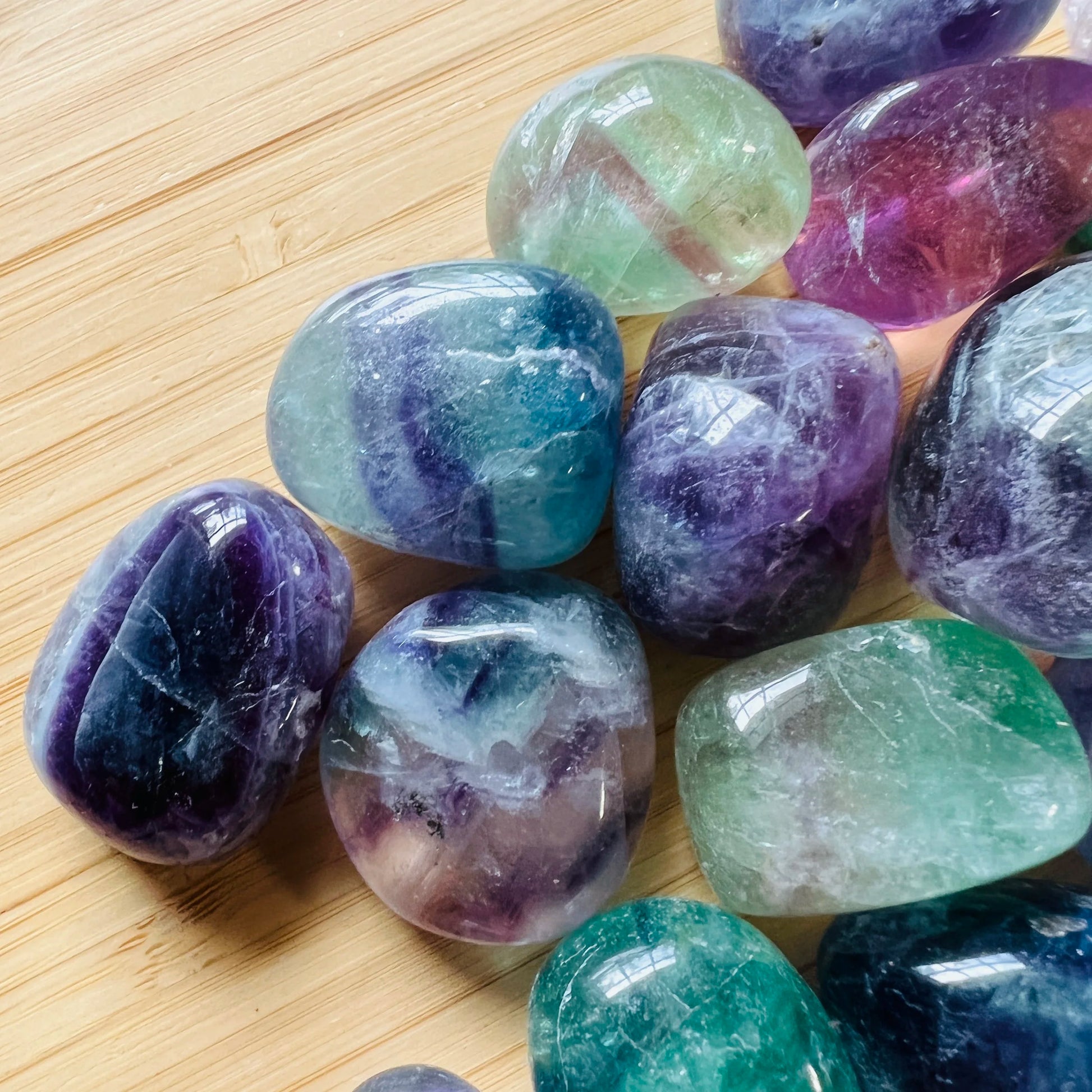 Detail shot of Grade AA Fluorite tumbled stone under natural light