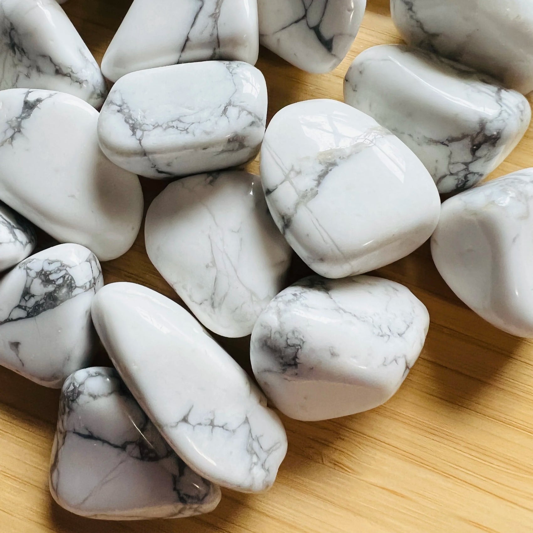 Detail shot of Grade AA Howlite tumbled stone under natural light