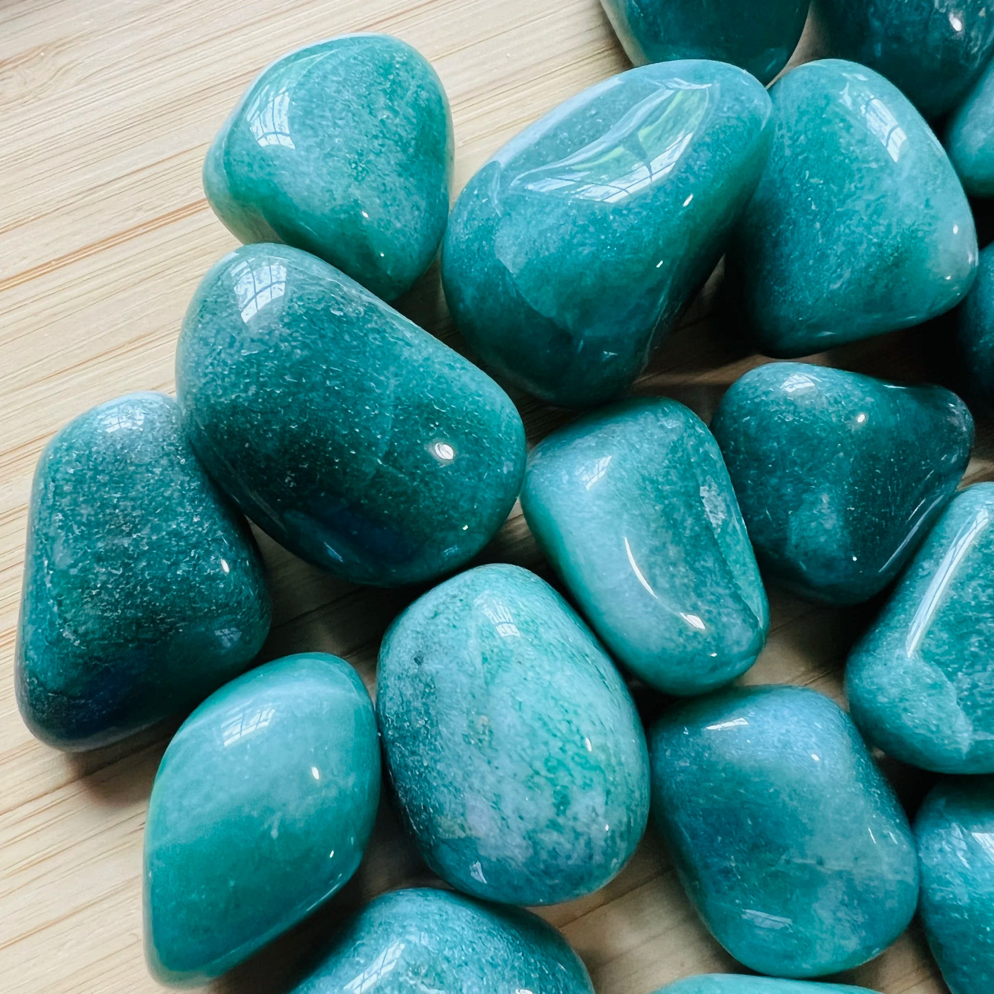 Side profile of Aventurine tumbled stone, showing natural sheen, sourced from Brazil.