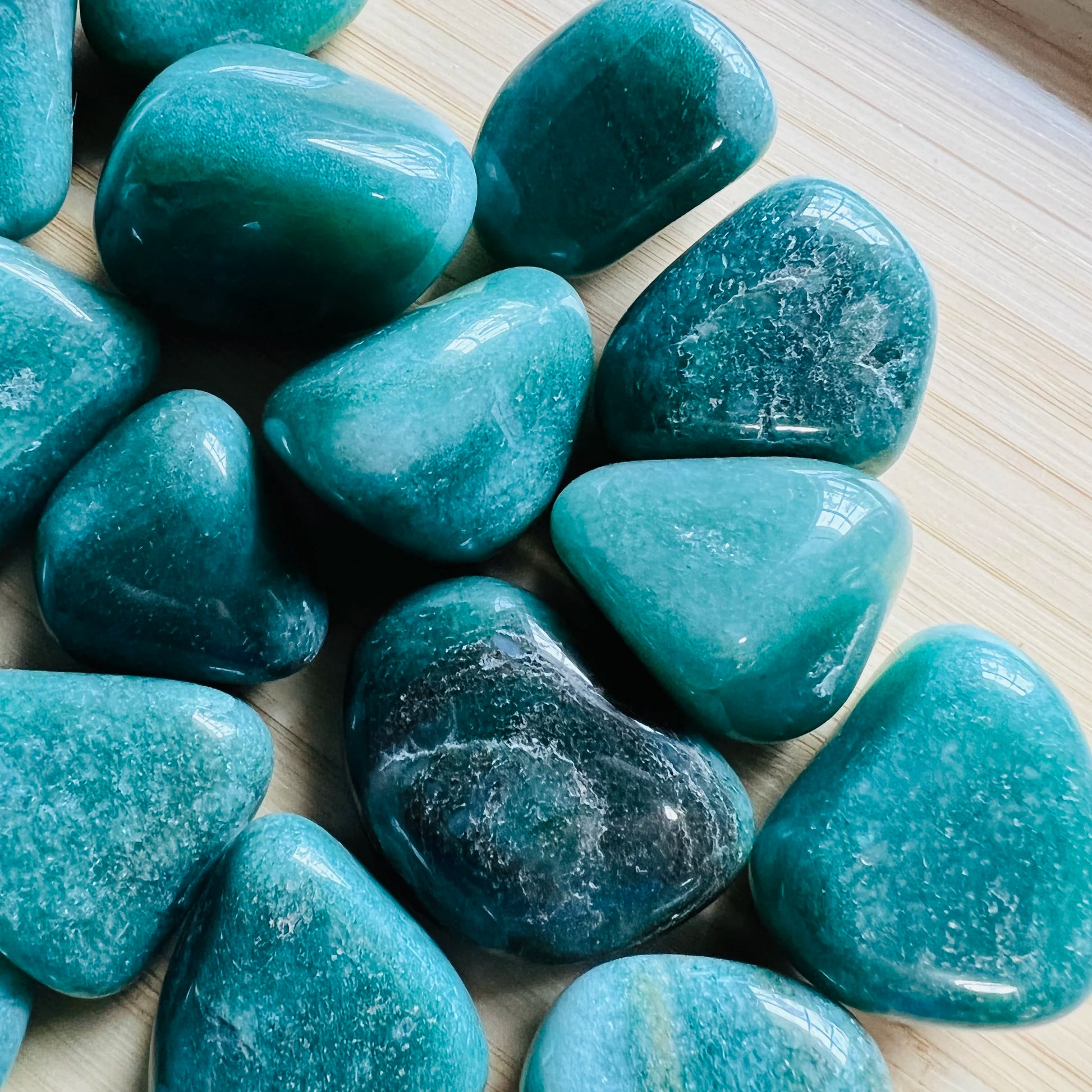 Reverse angle of Aventurine tumbled stone, showing natural inclusions, from Brazil.