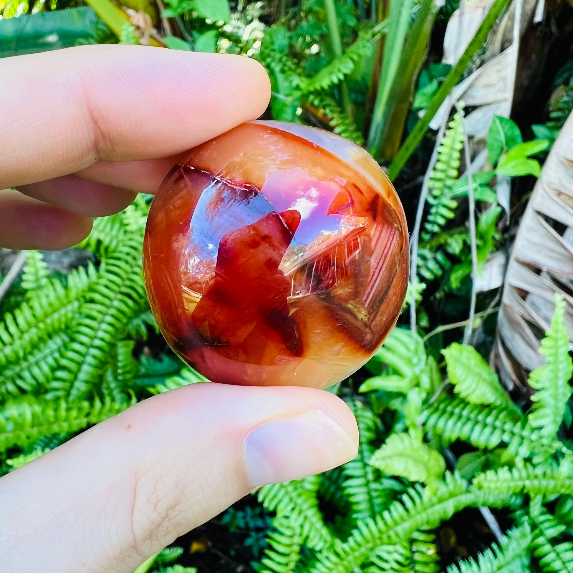 Back view of Grade AA Carnelian palm stone showing natural surface