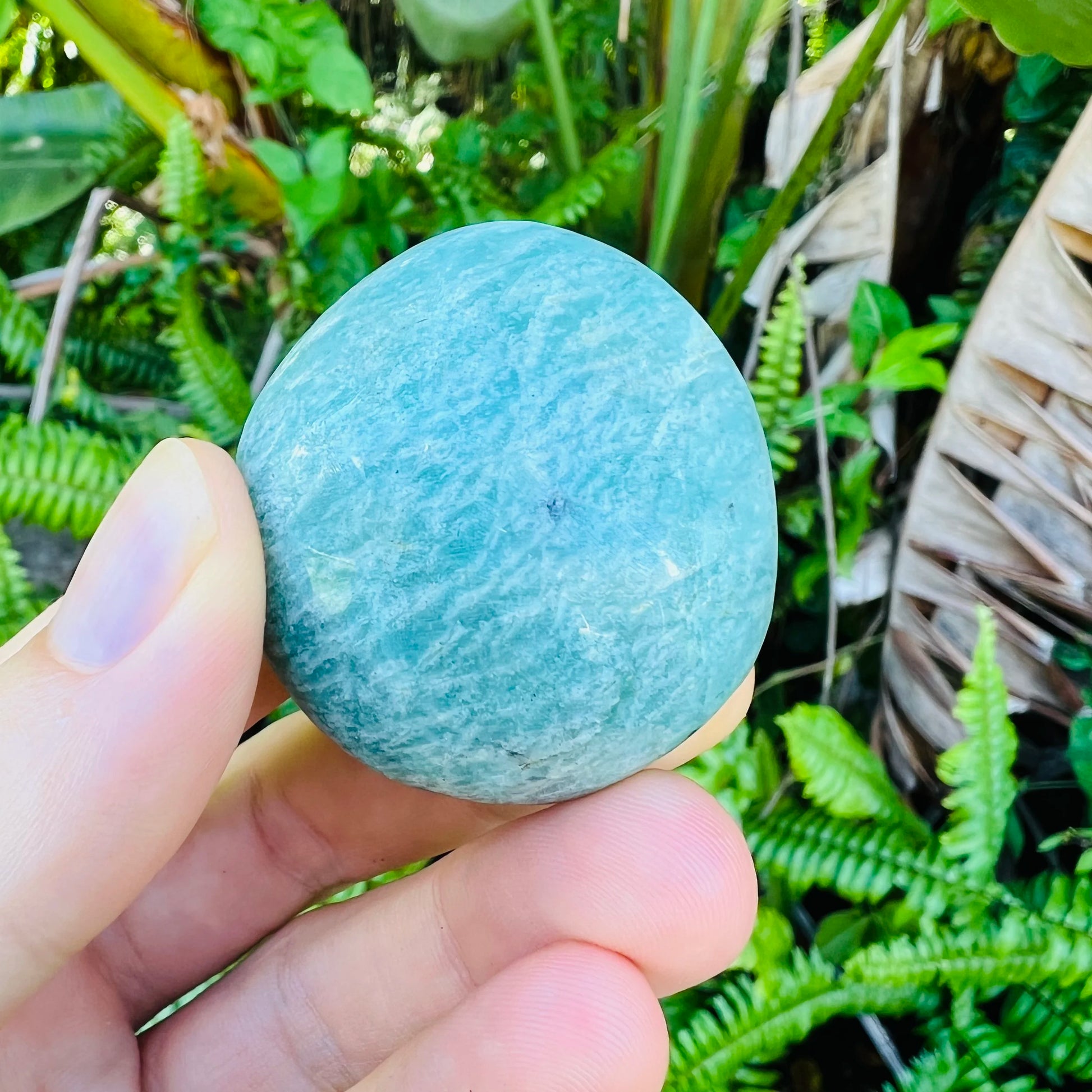 Back view of Grade A Amazonite palm stone showing natural surface