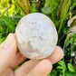 Back view of Grade AA Flower Agate palm stone showing natural surface