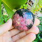 Macro view of Rhodonite palm stone, showing translucent edges, sourced from Atsimo-Andrefana, Madagascar.