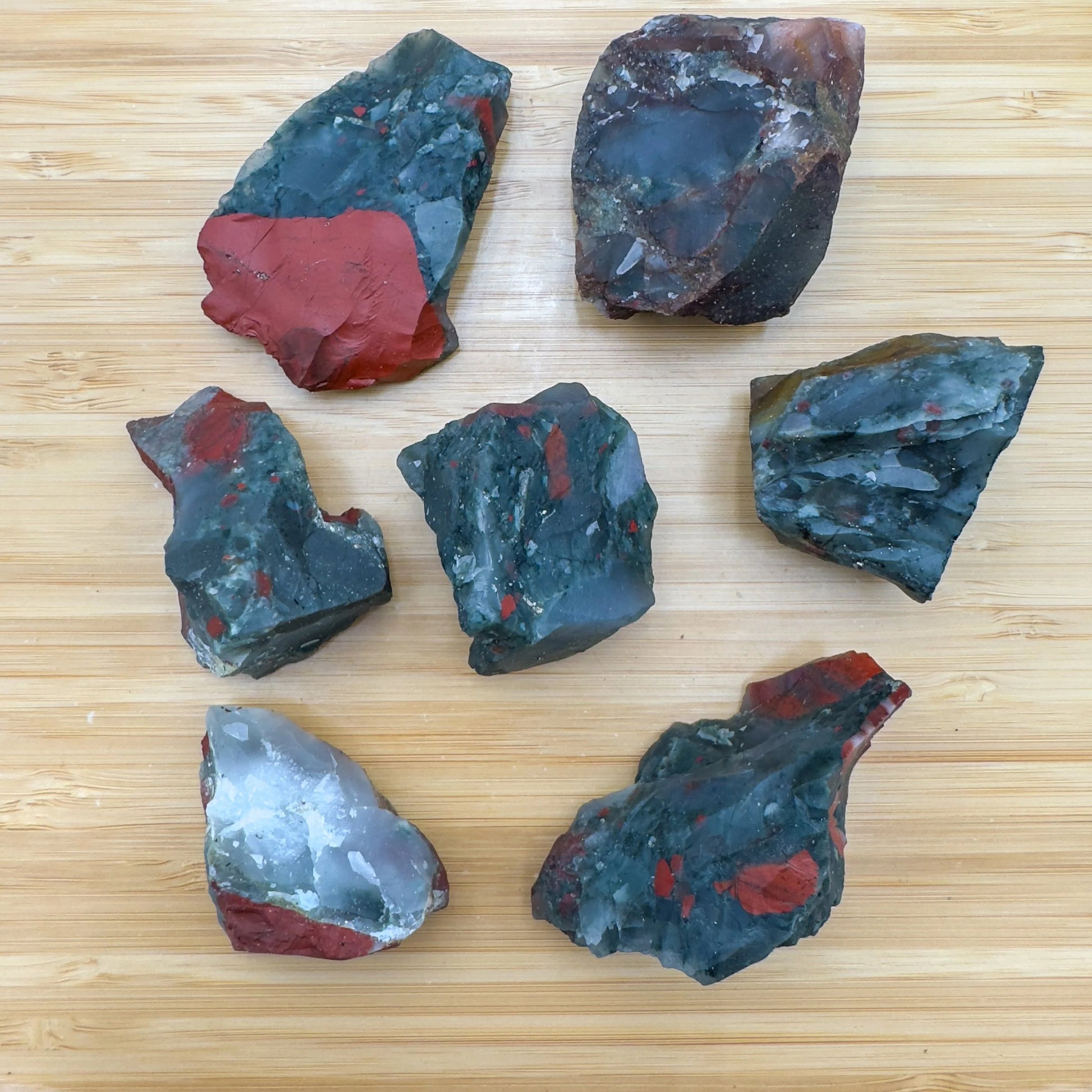 Sideways view of Bloodstone raw stone, from Hhohho, Eswatini, turned to for Energy and Protection.
