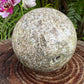Edge view of Ocean Jasper polished sphere, showing subtle veining, hand-selected from Sofia, Madagascar.